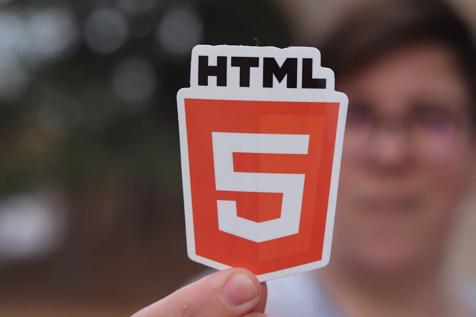 A close-up photograph of a computer screen displaying lines of HTML code in a code editor. The code highlights the structure of an HTML document, including the doctype declaration, html tag with langu